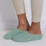 Totes Isotoner POPCORN TERRY Womens Mule Slippers Mint side view worn on feet with fitted leggings