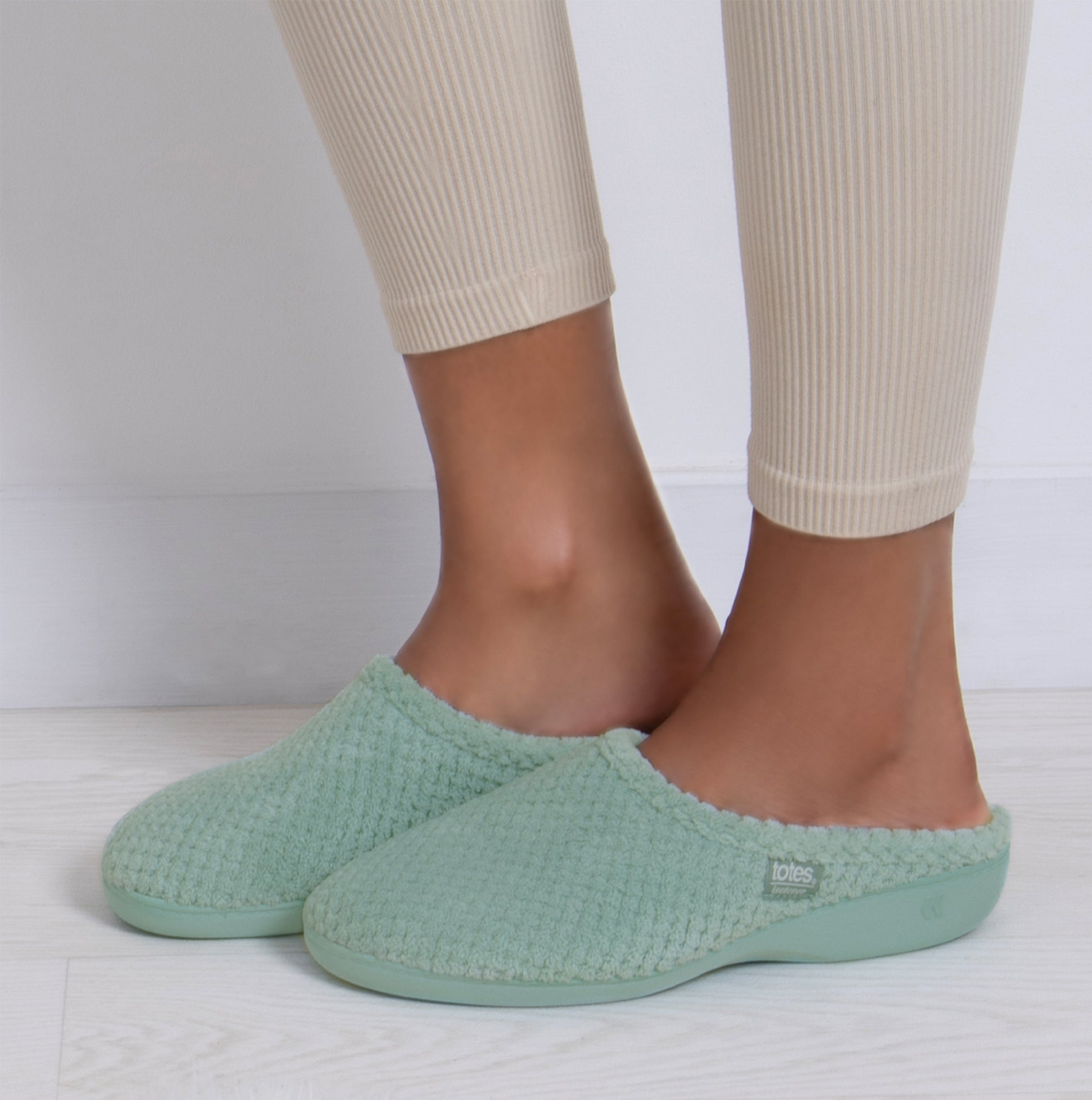 Totes Isotoner POPCORN TERRY Womens Mule Slippers Mint side view worn on feet with fitted leggings