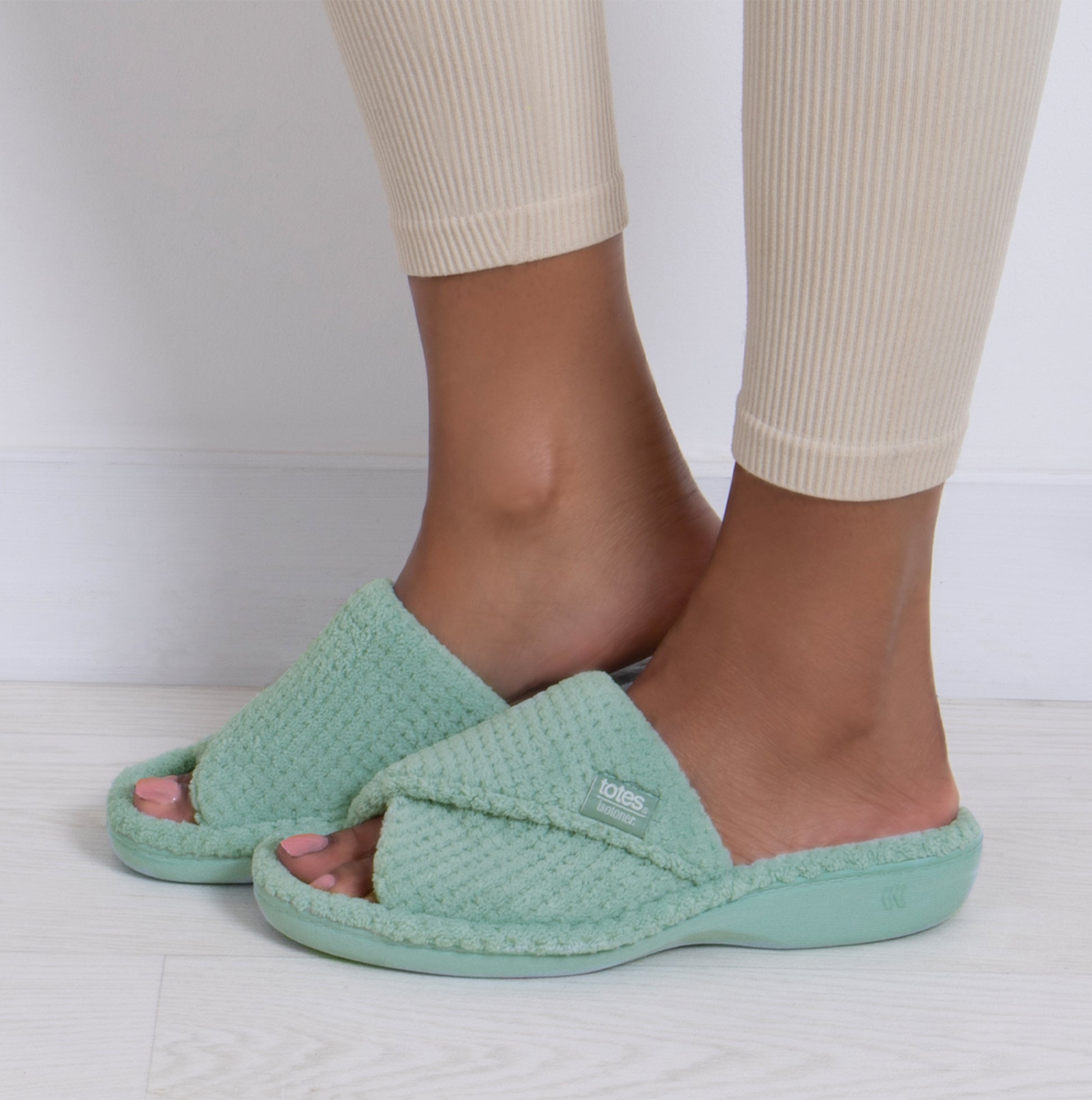 Totes Isotoner POPCORN TURNOVER OPEN TOE Womens Mule Slippers Mint side view on a model's feet.