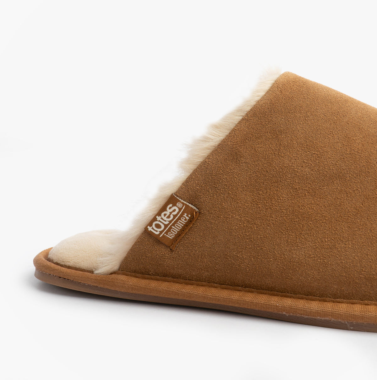 Totes Isotoner REAL SUEDE MULE Womens Slippers Tan side view showcasing soft suede upper and cozy lining.