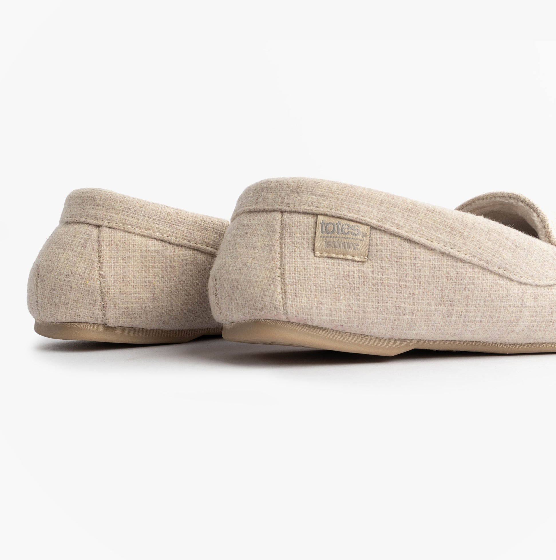 Totes Isotoner TEXTURED Womens Moccasin Slippers Light Brown side view showcasing soft fabric and slip-on design.