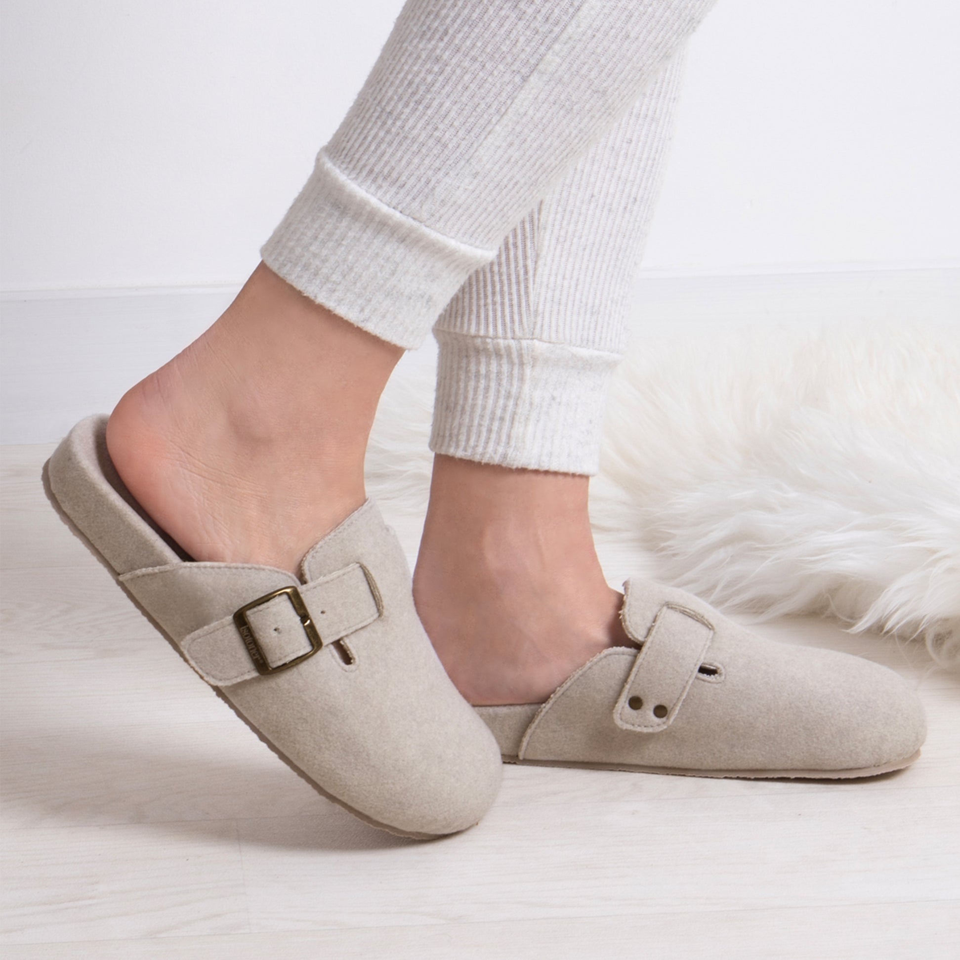 Totes Isotoner FELT CLOG Womens Clog Mule Slippers Oatmeal side view on a model wearing light pants.