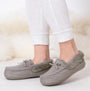 Totes Isotoner HERRINGBONE MOCCASIN WITH FUR CUFF Womens Slippers Grey side view on model's feet with white leggings