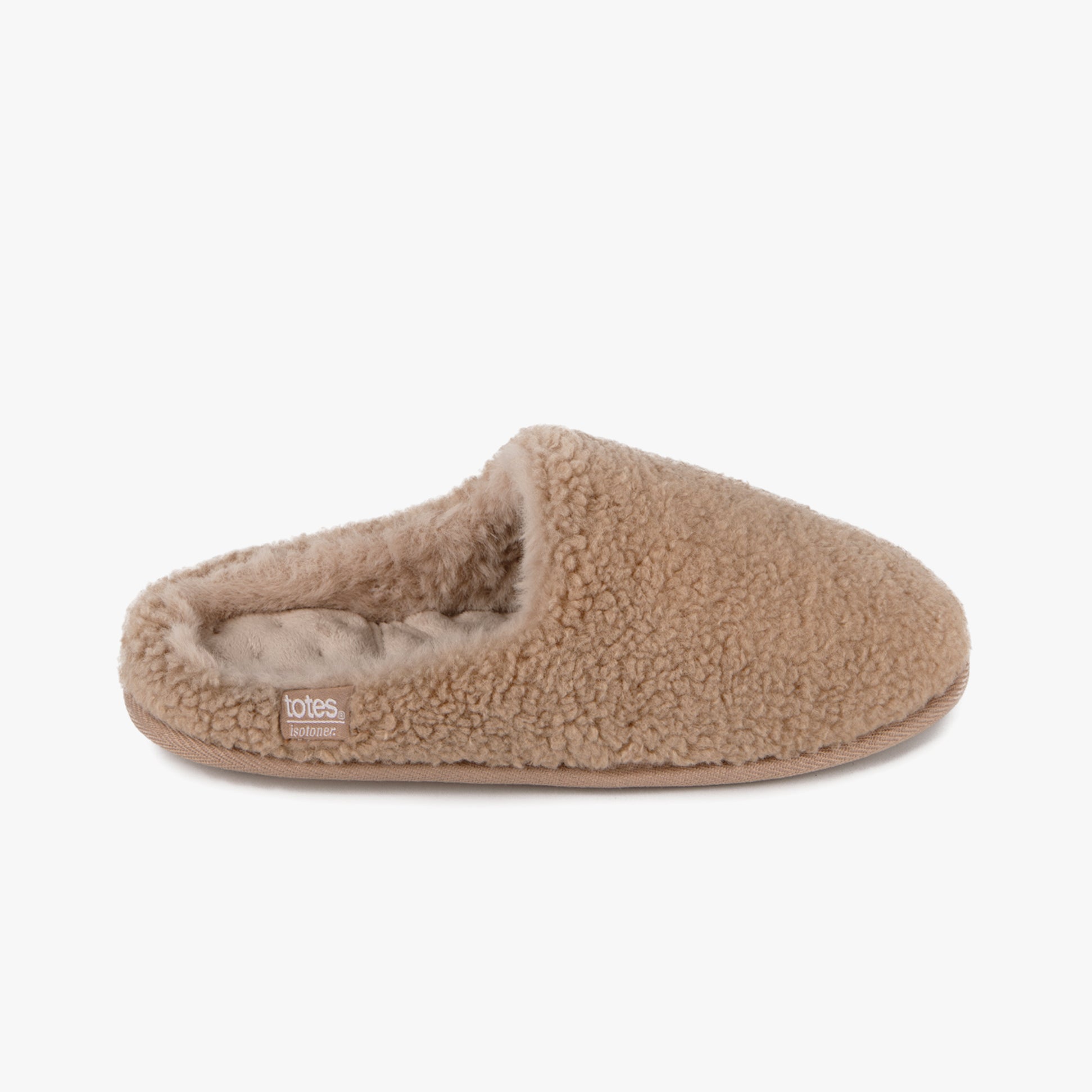 Totes Isotoner CURLY FUR MULE Womens Mule Slippers Natural side view showing cozy fur texture and slip-on design.