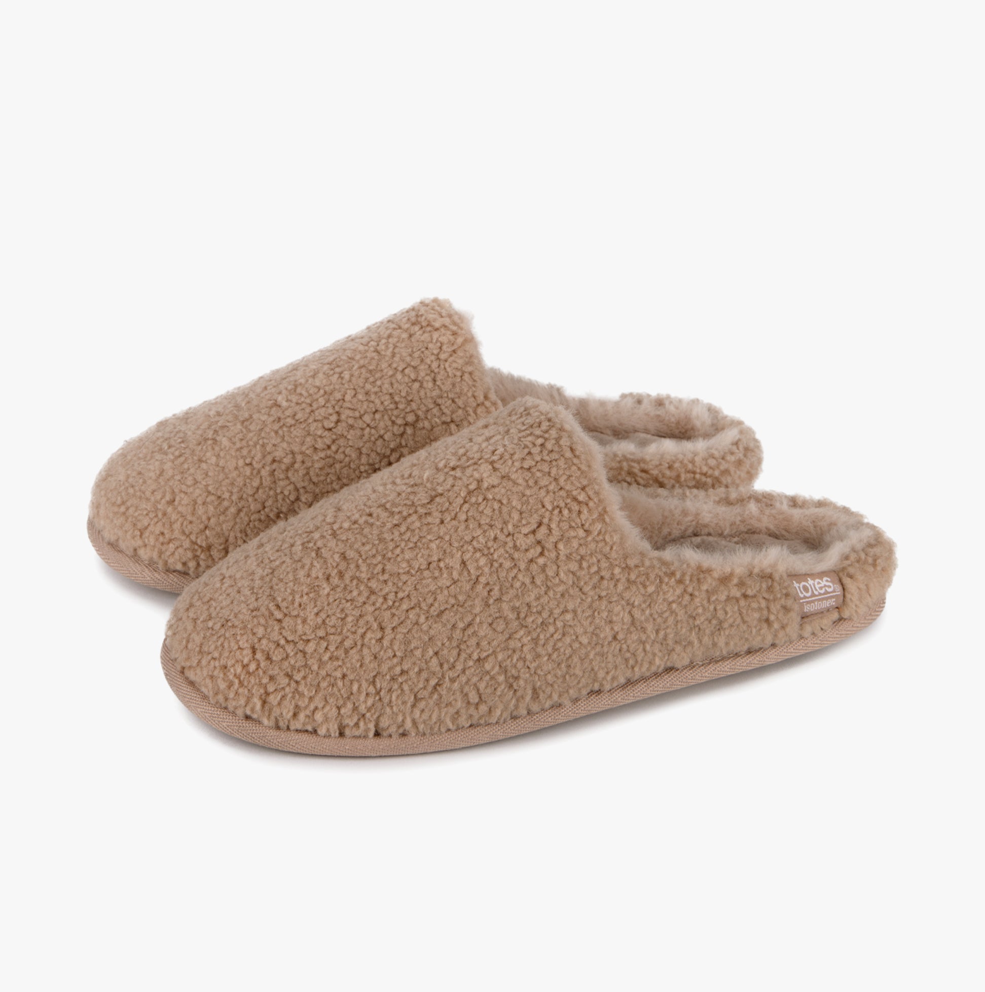 Totes Isotoner CURLY FUR MULE Womens Mule Slippers Natural side view showcasing cozy fleece texture and slip-on design.