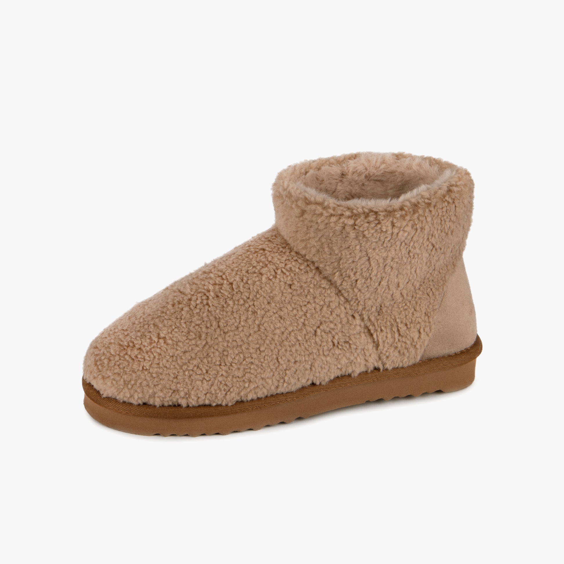 Totes Isotoner CURLY FUR BOOT Womens Bootie Slippers Natural side view showing soft curly fur material and cozy design.