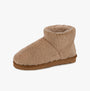 Totes Isotoner CURLY FUR BOOT Womens Bootie Slippers Natural side view showing soft curly fur material and cozy design.