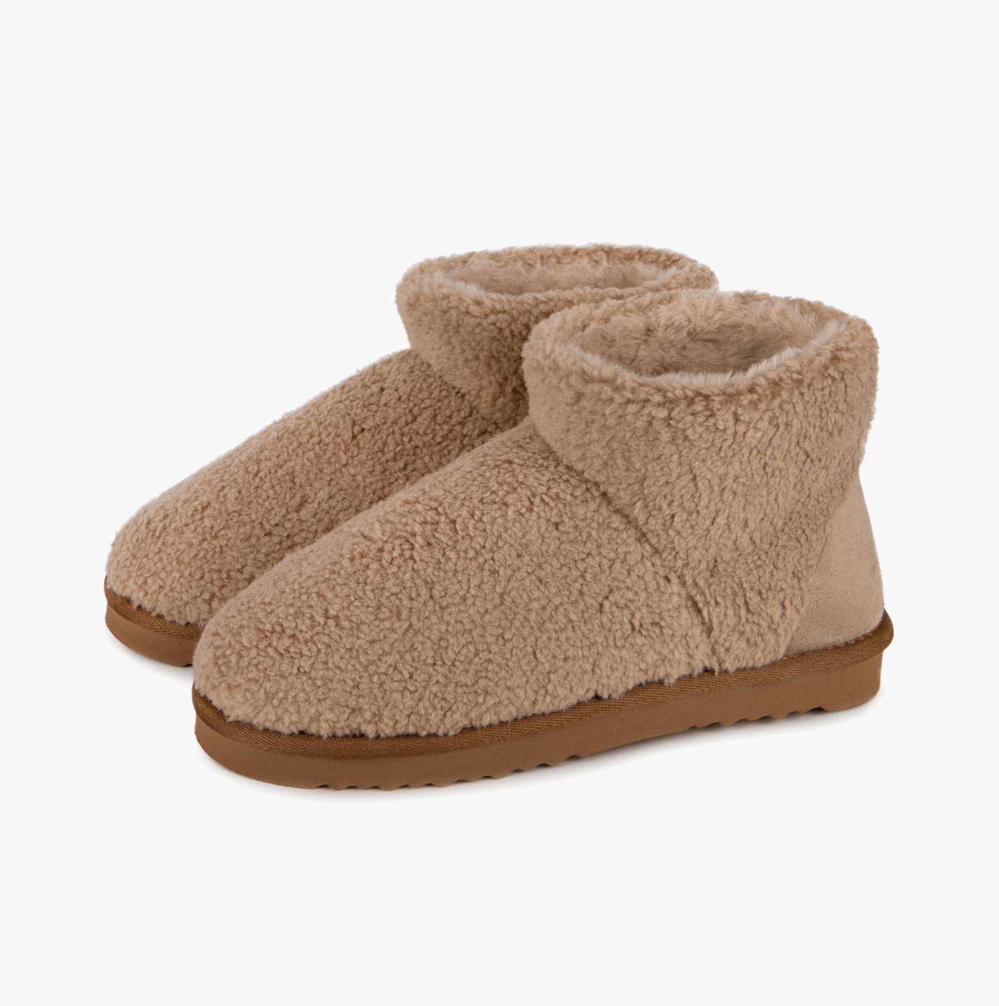 Totes Isotoner CURLY FUR BOOT Womens Bootie Slippers Natural side view showing soft curly fur and comfortable design.