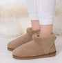 Totes Isotoner CURLY FUR BOOT Womens Bootie Slippers Natural side view showing cozy curly fur design and soft textile lining.