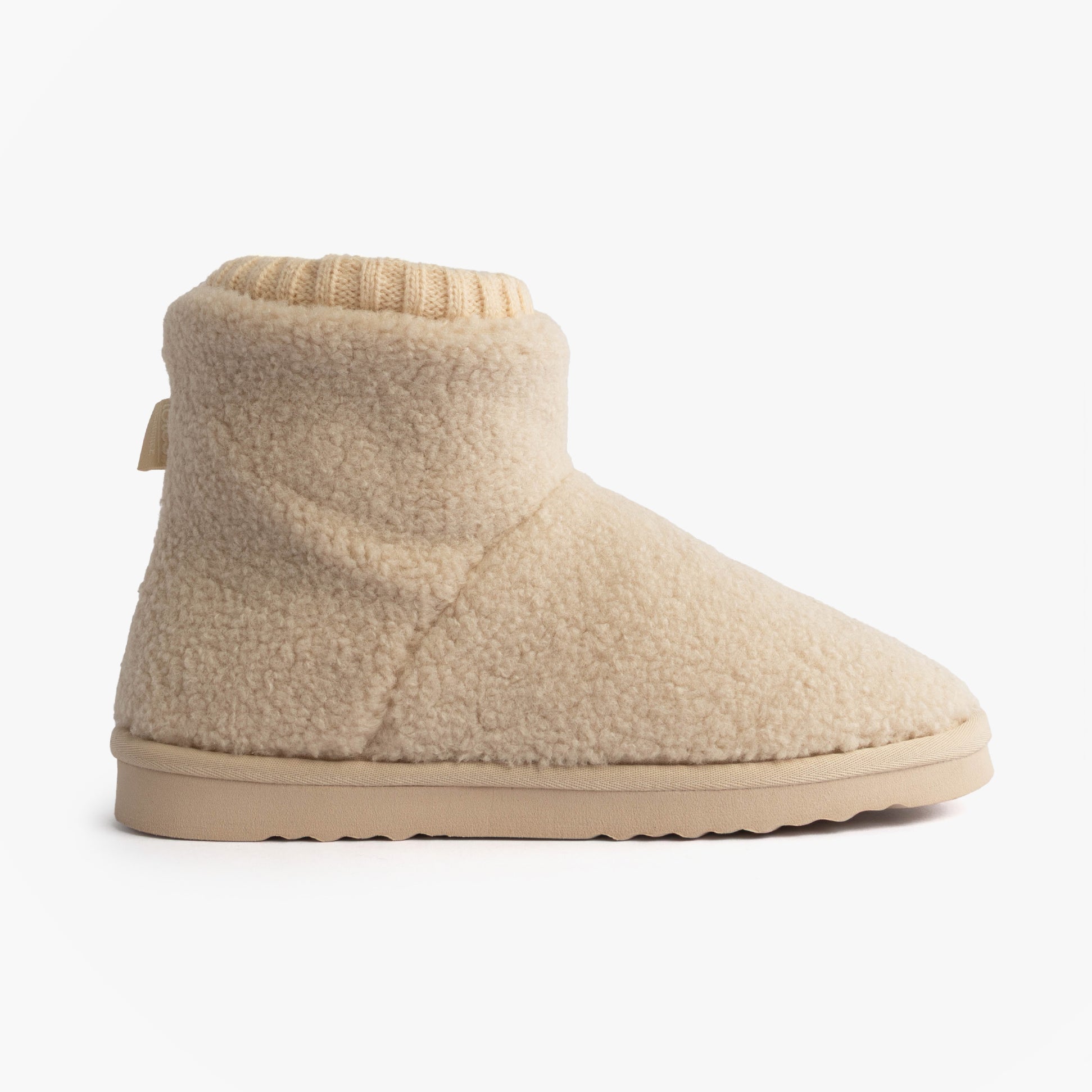 Totes Isotoner BORG BOOT WITH CUFF DETAIL Womens Boot Slippers Cream side view with soft plush material and flexible sole.