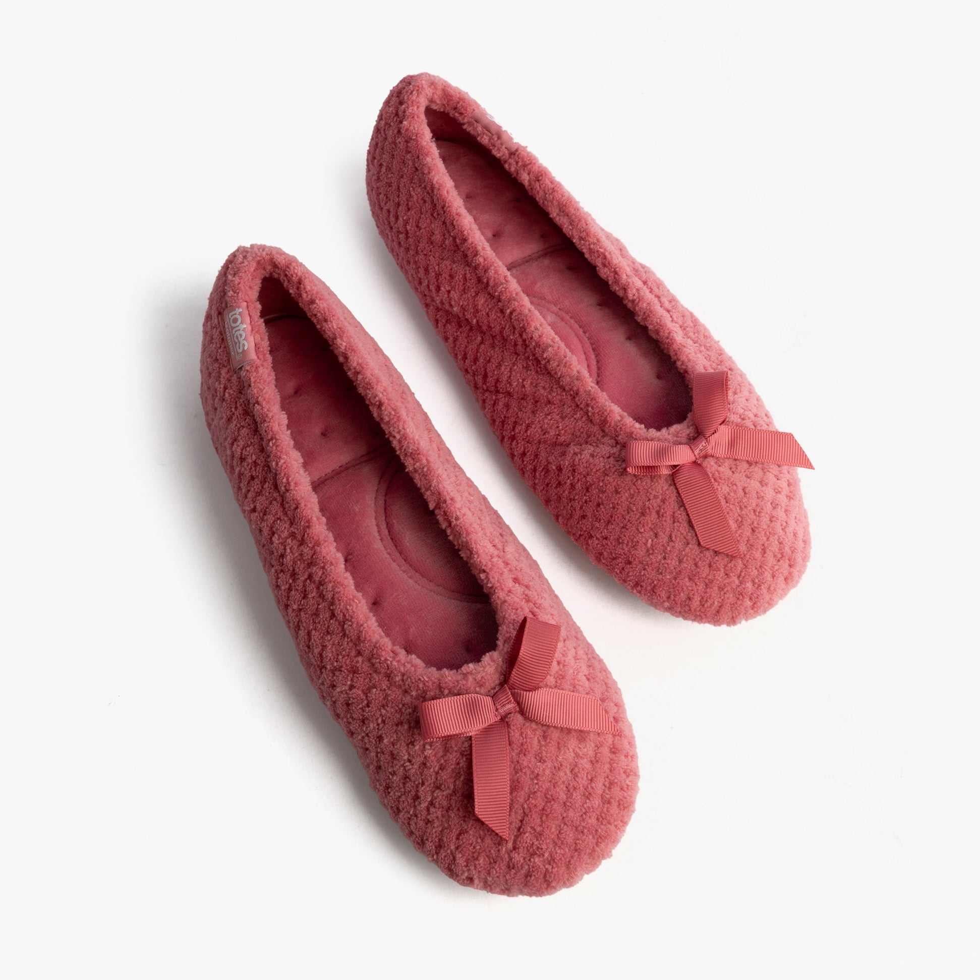 Totes Isotoner POPCORN BALLET Womens Ballerina Slippers Bright Pink top view showcasing soft texture and bows.