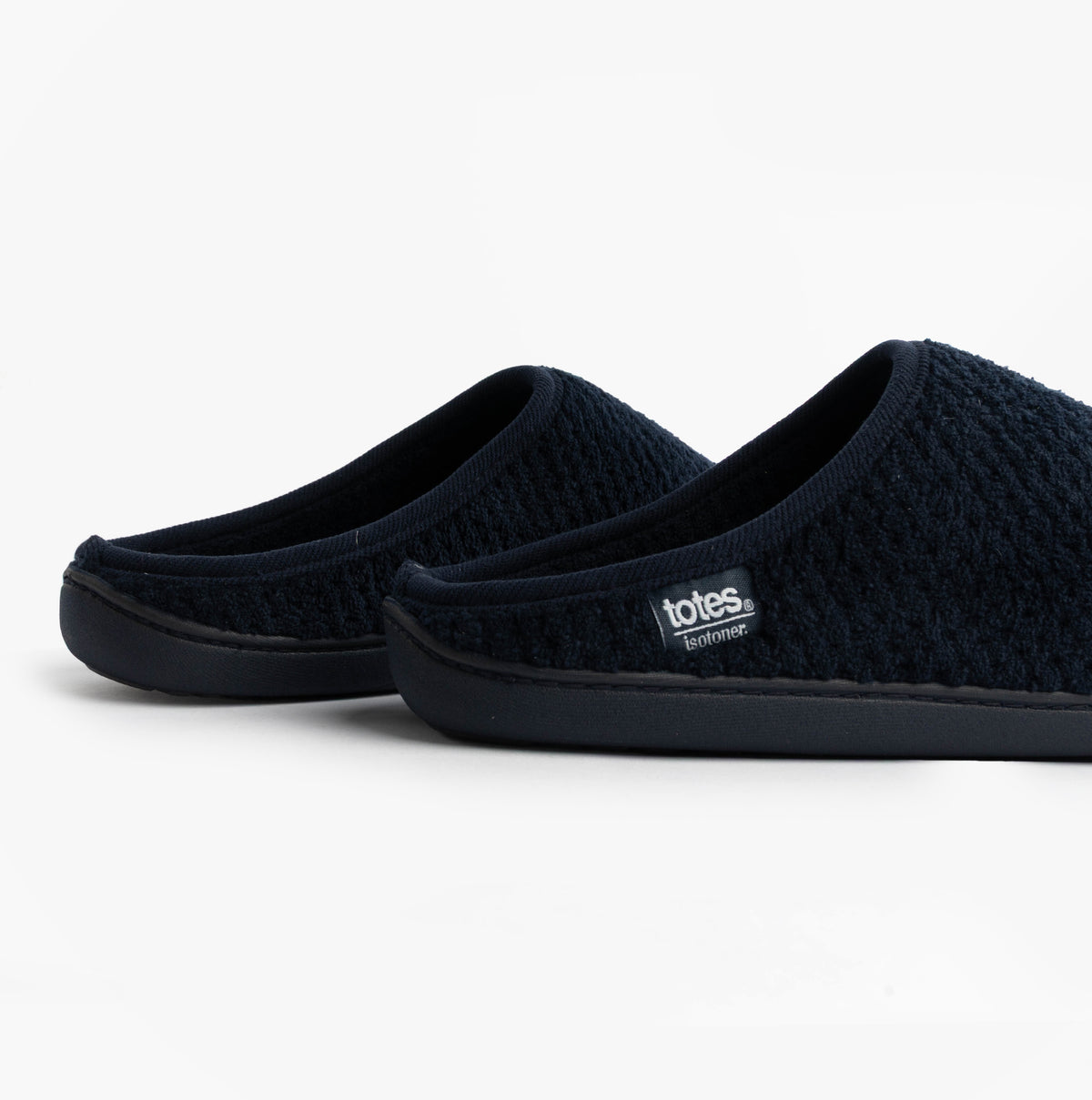 Totes Isotoner SWEPT BACK POPCORN MULE Mens Mule Slippers Navy side view showcasing soft textured upper and slip-on design.
