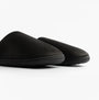 Totes Isotoner SQUARE PATTERNED SMART MULE Mens Mule Slippers Black side view showing textured upper and rounded toe.