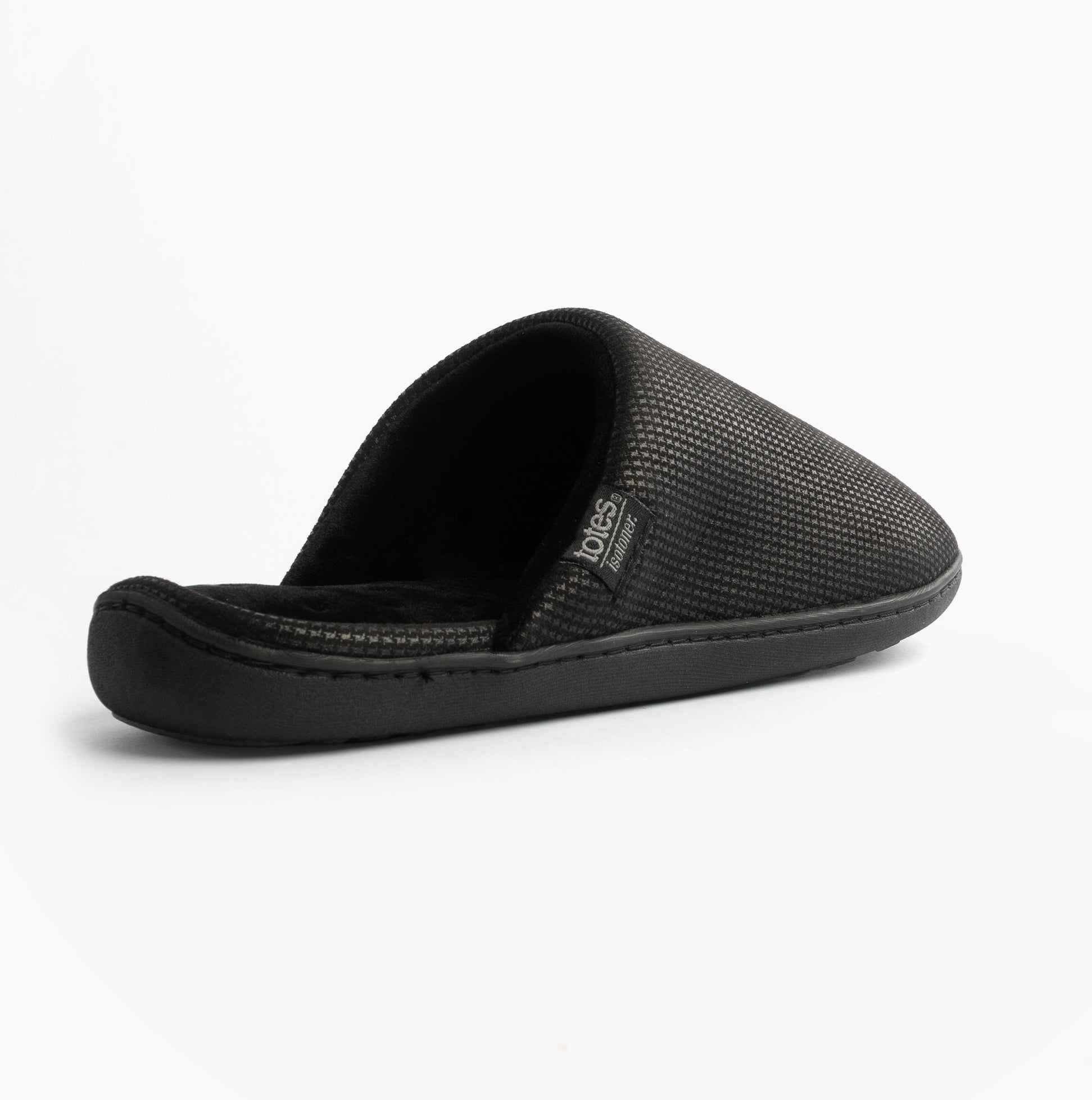 Totes Isotoner SQUARE PATTERNED SMART MULE Mens Mule Slippers Black side view showing textured upper and slip-on design.