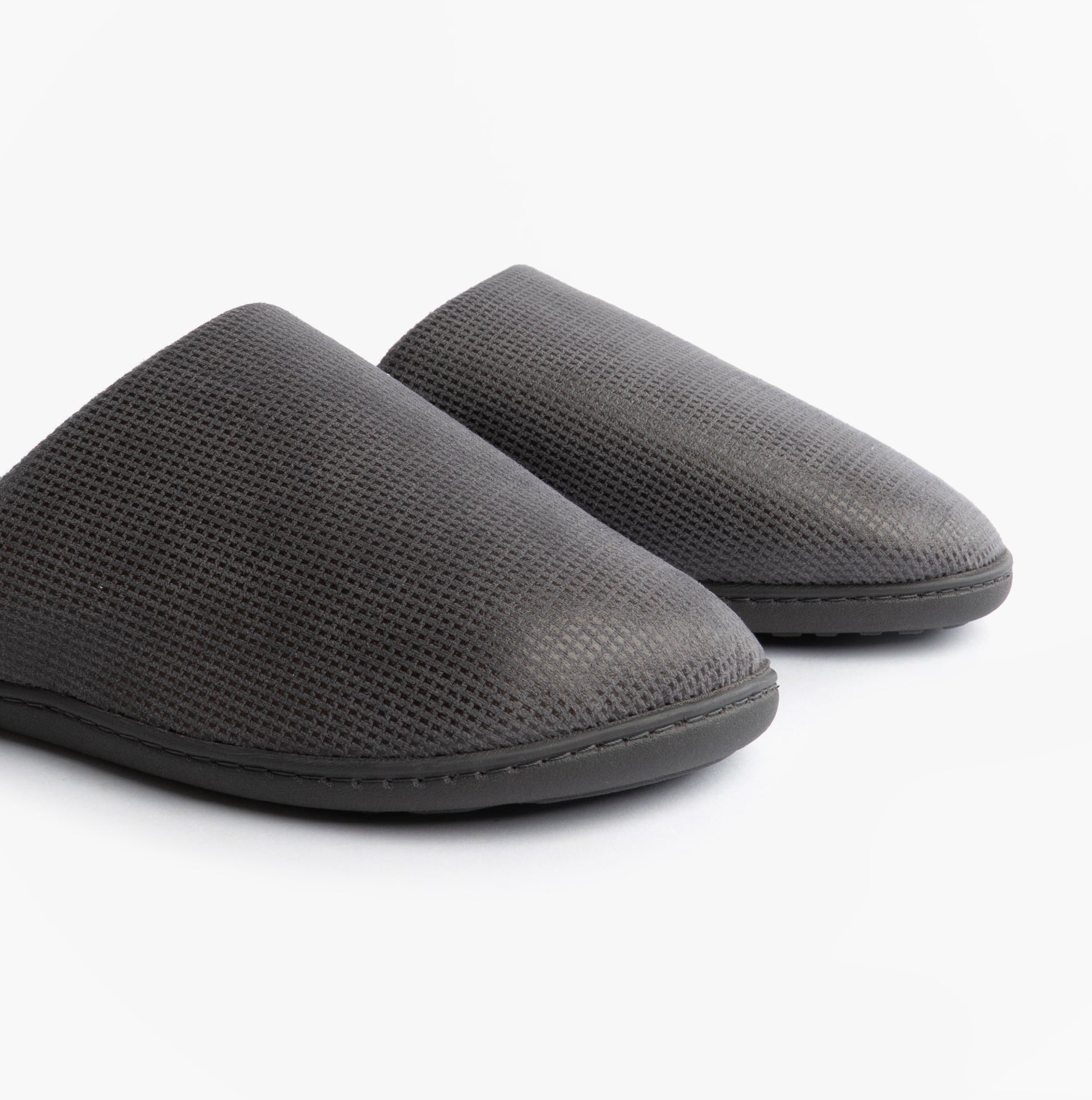 Totes Isotoner SQUARE PATTERNED SMART MULE Mens Mule Slippers Grey side view showing textured upper and round toe design.