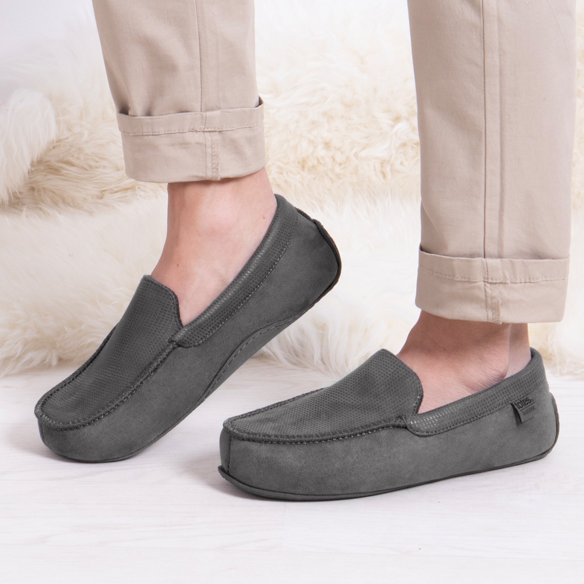 Totes Isotoner SQUARE PATTERNED SMART MOCCASIN Mens Moccasin Slippers Grey side view worn with beige trousers.