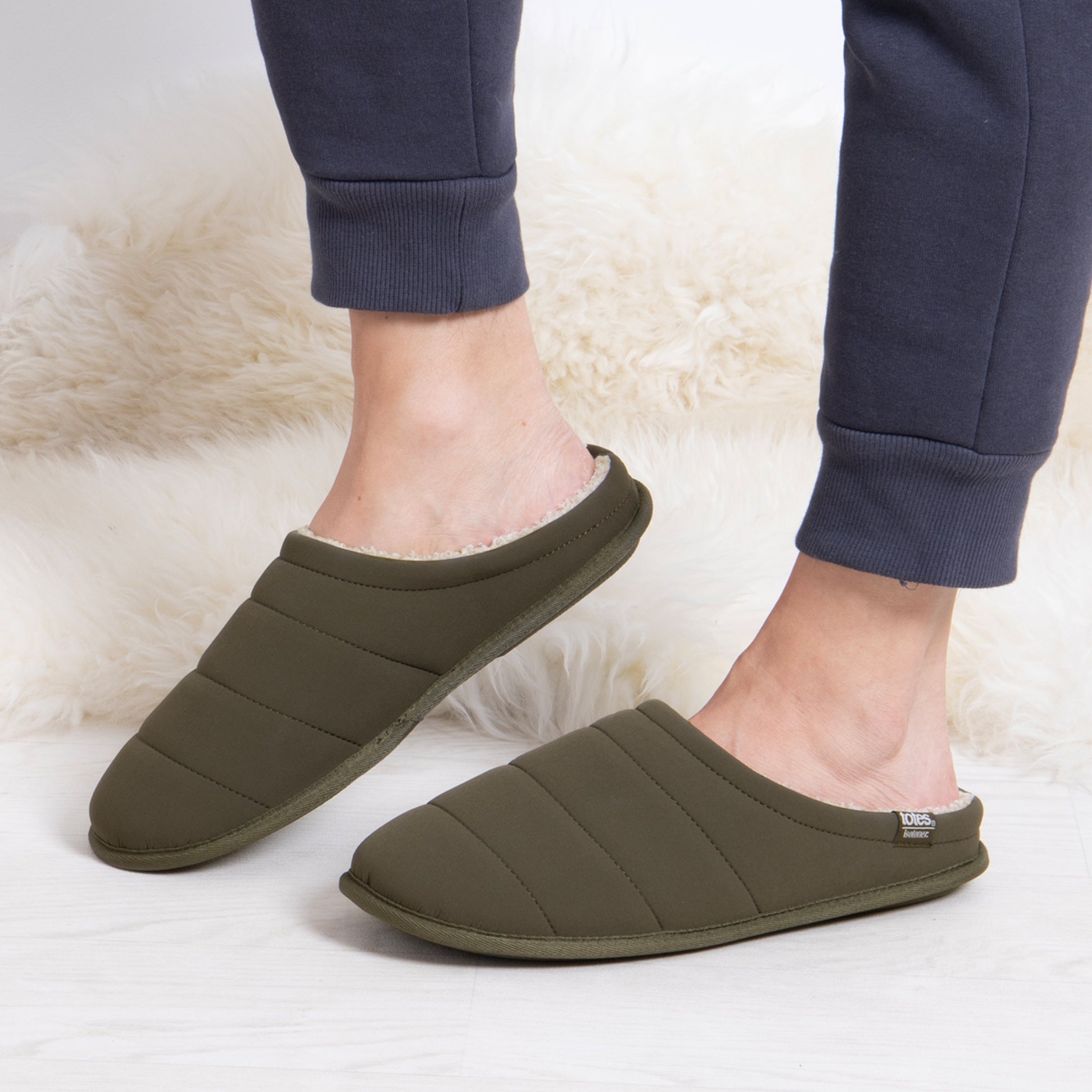 Totes Isotoner SPORT QUILTED MULE WITH COSY LINING Mens Mule Slippers Khaki side view worn with joggers on a light background