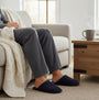 Totes Toasties CENTRE SEAM Mule Slippers Mens Navy side view worn on feet while sitting on a couch