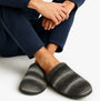 Totes Toasties KNITTED OMBRE Mule Slippers Mens Grey side view worn with navy outfit, highlighting the grey and black ombre design.