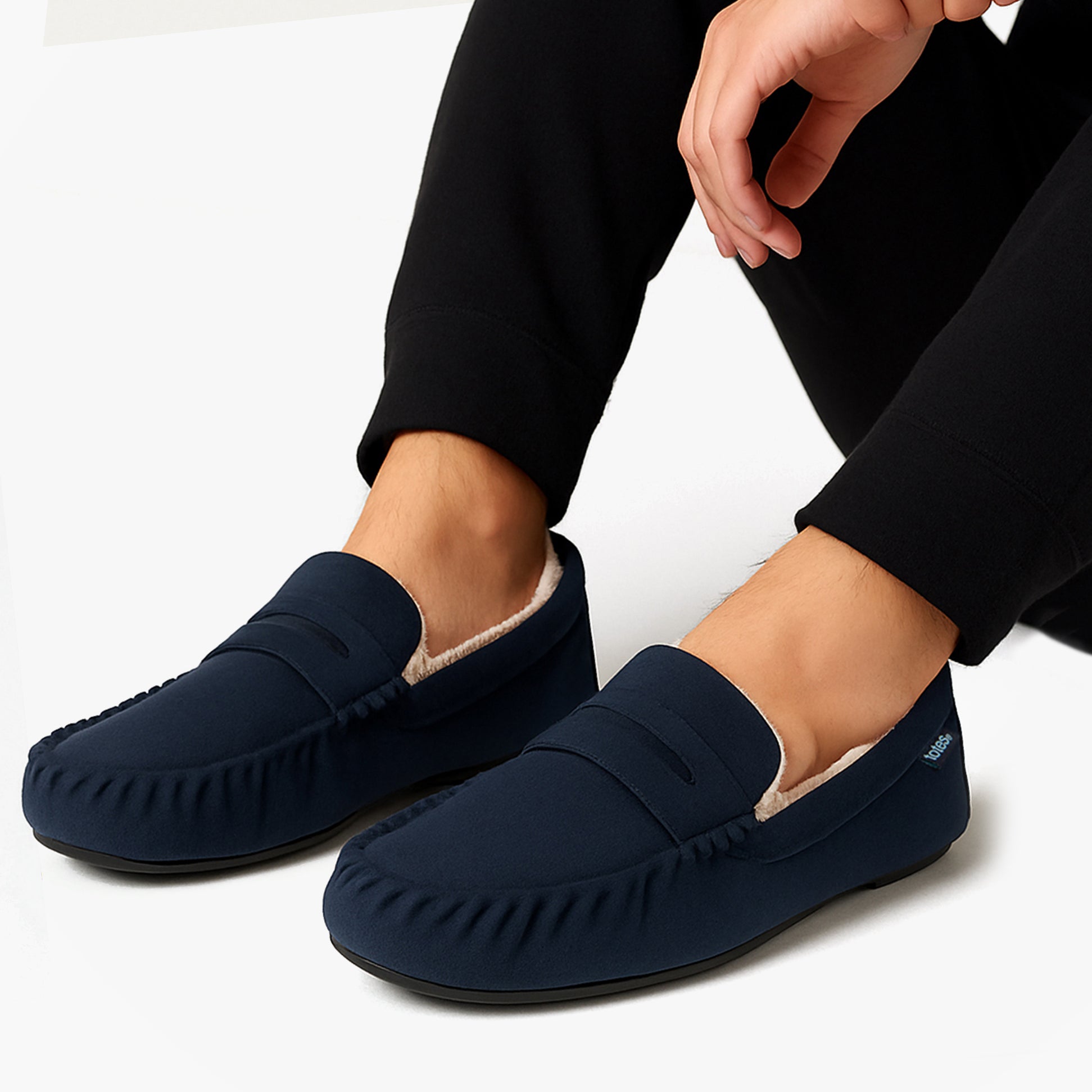 Totes Toasties SUEDETTE Moccasin Slippers Mens Navy side view worn by a man, showcasing comfort and faux fur lining.