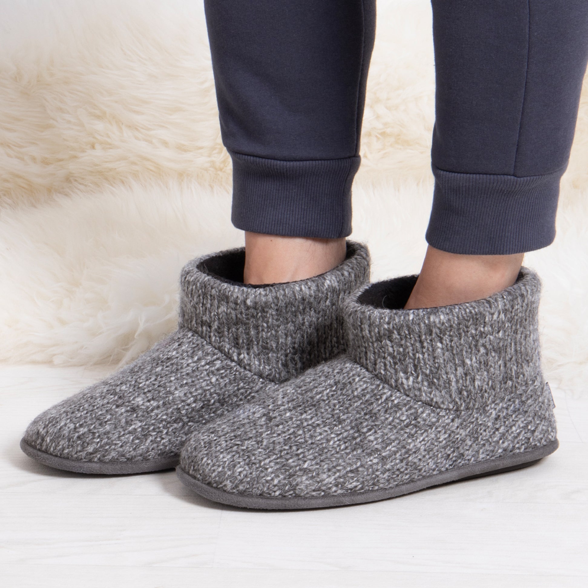 Totes Toasties KNITTED SHORT BOOT SLIPPER Mens Grey side view on model's feet, showcasing cozy knitted design.