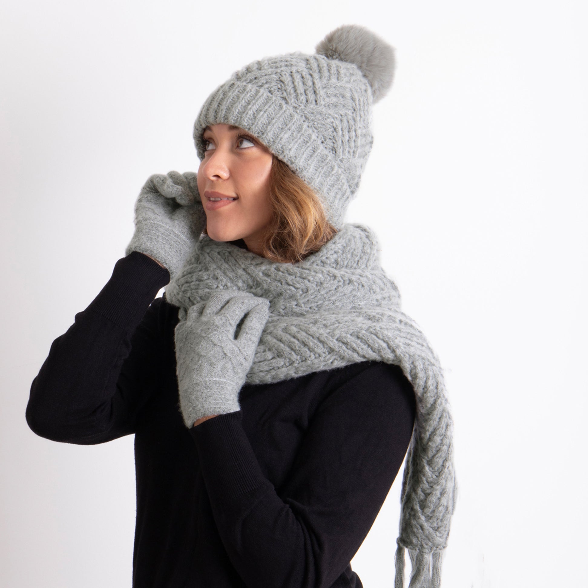 Totes Toasties KNITTED HAT SCARF & MITTEN GIFT SET Womens Grey, side view of model wearing hat, scarf, and mittens.
