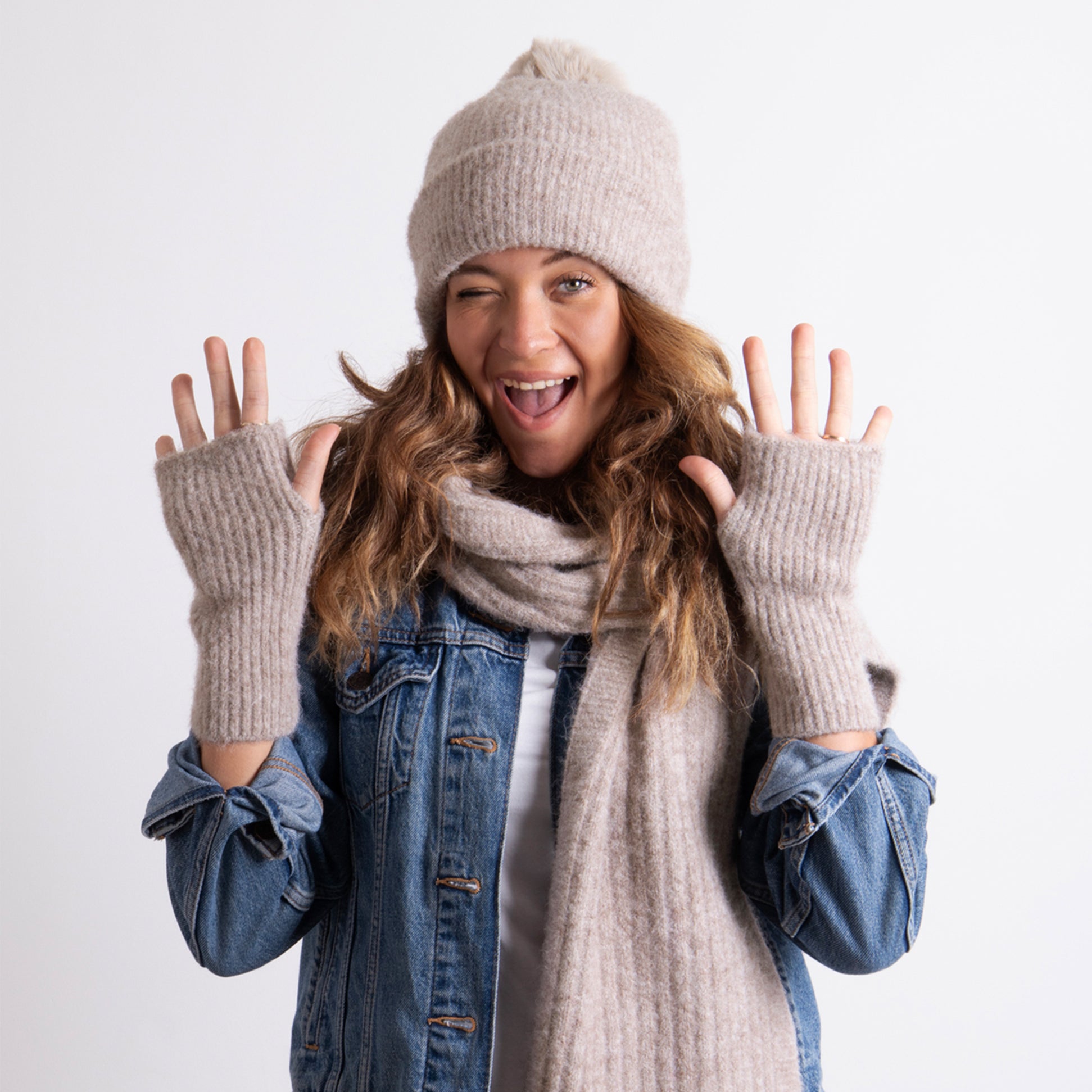 Totes Toasties KNITTED HAT SCARF & ARM WARMER GIFT SET Womens Oat, front view of model wearing hat, scarf and arm warmers, smiling.