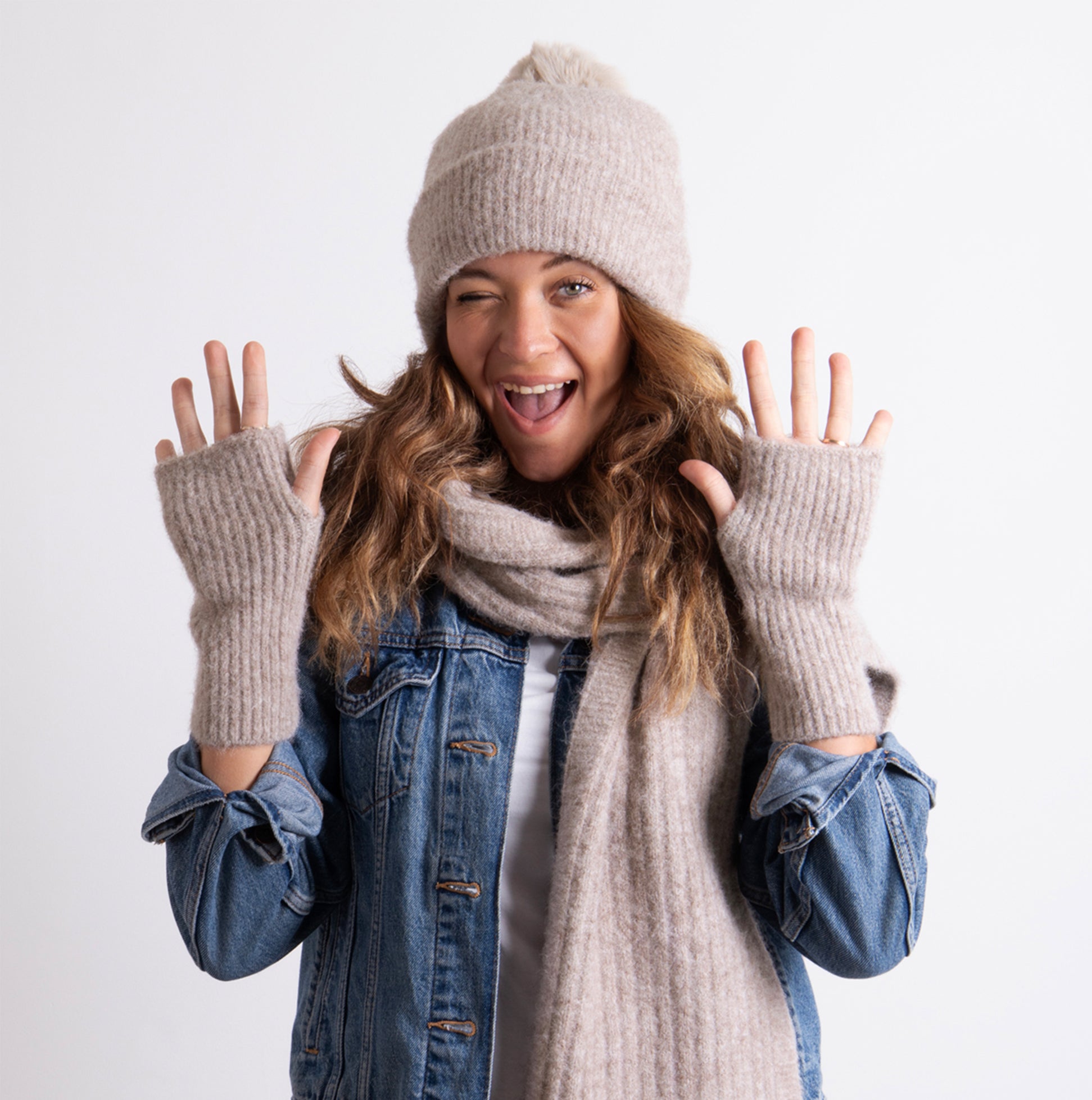 Totes Toasties KNITTED HAT SCARF & ARM WARMER GIFT SET Womens Oat, front view of model wearing hat, scarf and arm warmers, smiling.