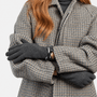 Totes Isotoner THERMAL GLOVE WITH BOW DETAIL Womens Touchscreen Gloves Grey worn by a woman in a stylish coat.
