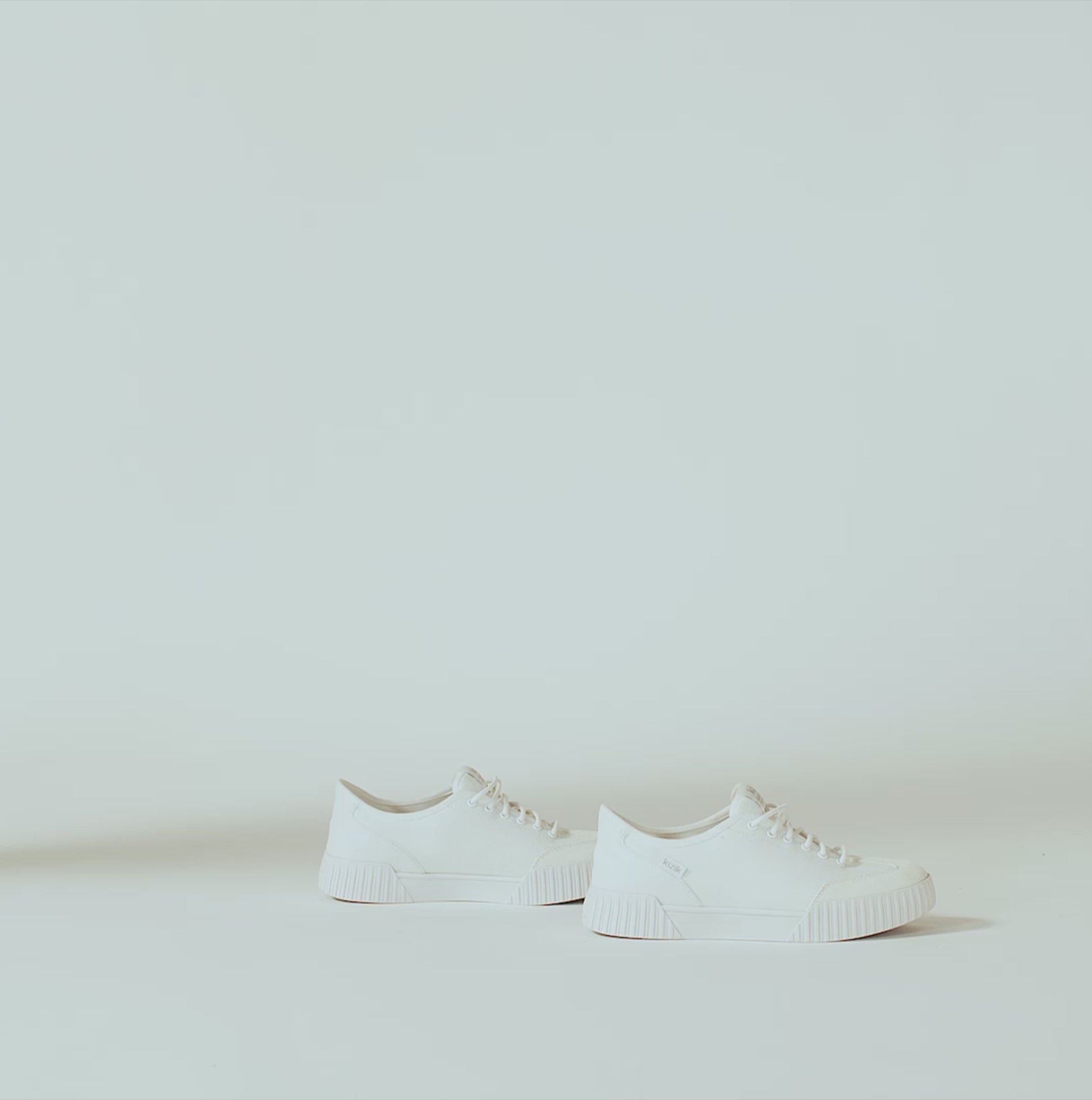 Kizik BROOKLYN Womens Trainers Bright White side view on a light background, showcasing lace-up design and low top style.