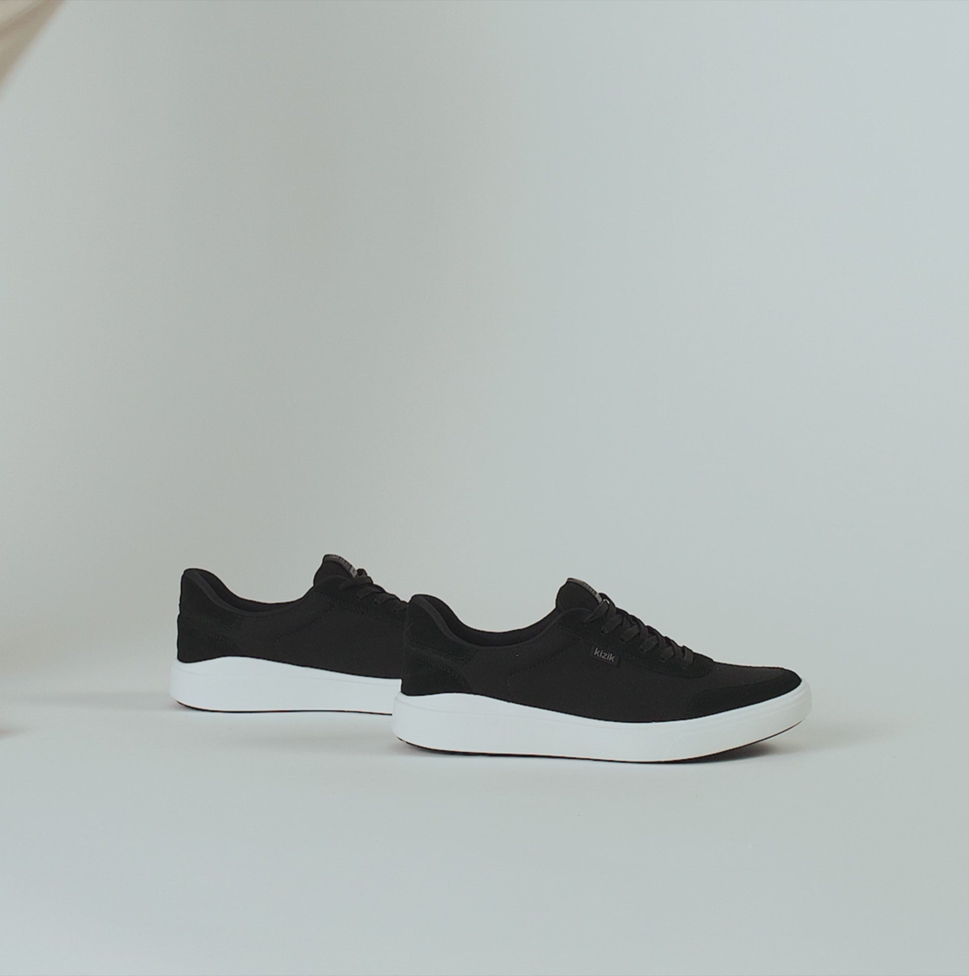 Kizik PRAGUE 2.0 Mens Trainers Black side view showcasing stylish canvas trainers with lace-up closure.
