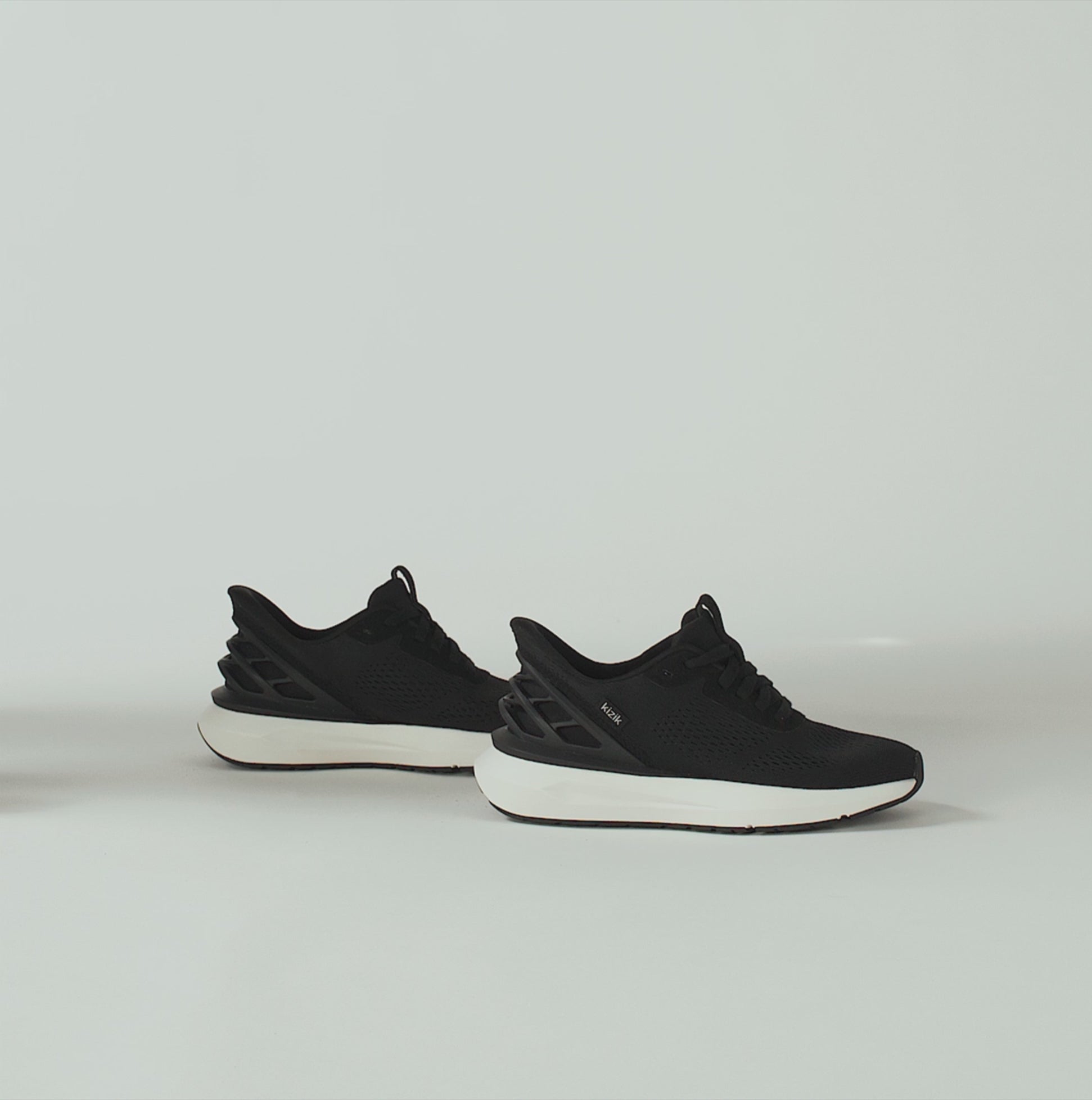 Kizik ATHENS 2.0 Womens Trainers Black side view showcasing the stylish black mesh upper and rubber sole.